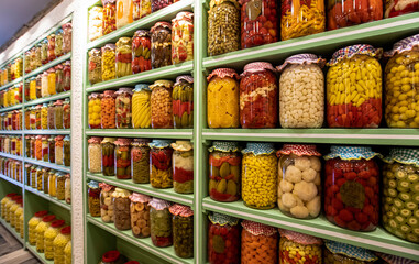 Lots of colorful pickles in bottles, jars of pickles, different pickled vegetables ...