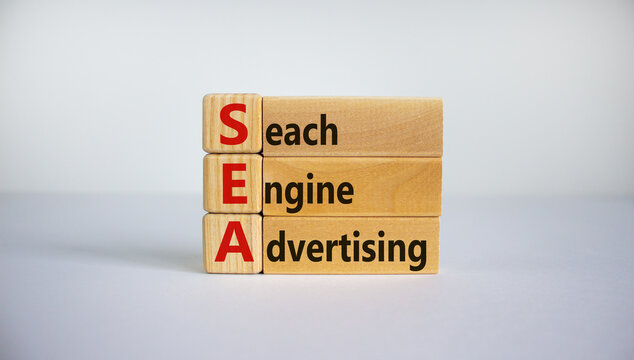 SEA - search engine advertising symbol. Wooden cubes with words 'SEA - search engine advertising'. Beautiful white background, copy space. Business and SEA - search engine advertising concept.