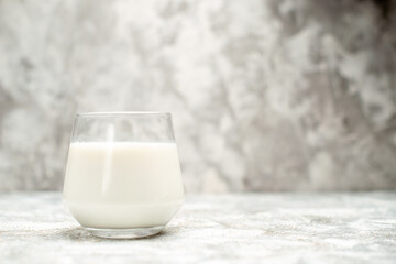 front view a glass of milk on grey-white isolated background with copy space