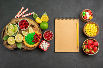 top view yummy creamy cake with candies and fruits on dark background sweet cookie biscuit