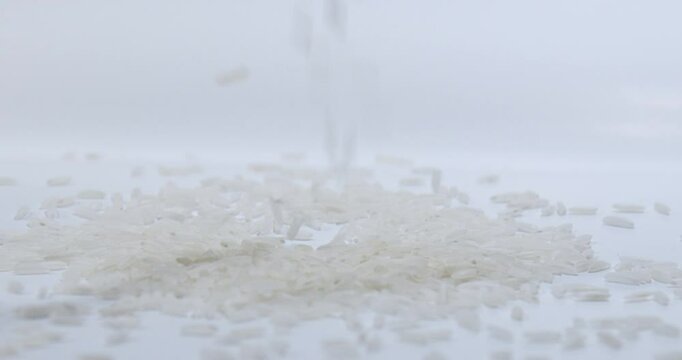 Rice falling in Slow Motion onto a white surface. Isolated on white. 120 FPS.