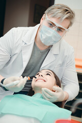 A professional checks the condition of the client's oral cavity