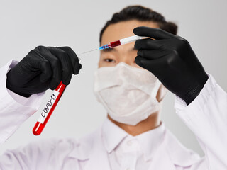 Asian male black gloves Test tube with blood syringe research