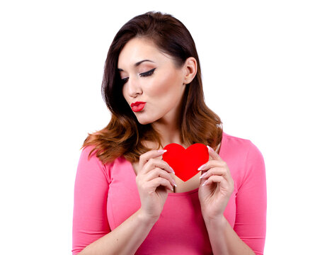 A pretty Caucasian girl is holding a red paper heart.  isolated. white background. isolated