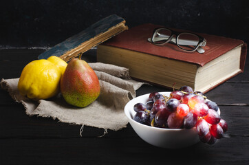 Books and fresh fruits on the wooden table