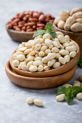 Fototapeta na wymiar Raw dried fresh peanut nuts on a stone background