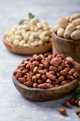 Raw dried fresh peanut nuts on a stone background