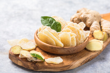 Slices of ginger dried fruit  and ginger root on a stone table. Against viruses and diseases. immune product.