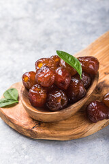 Dates or dattes palm fruit in wooden bowl is snack healthy.Creative layout made of dried dates. Flat lay. Food concept. Fruits dates. Dates Palm fruit isolated on white. Dried fruits. Healthy diet.