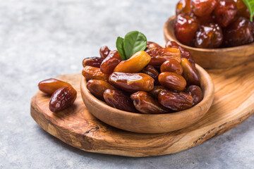 Dates or dattes palm fruit in wooden bowl is snack healthy.Creative layout made of dried dates....