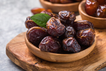 Dates or dattes palm fruit in wooden bowl is snack healthy.Creative layout made of dried dates. Flat lay. Food concept. Fruits dates. Dates Palm fruit isolated on white. Dried fruits. Healthy diet.