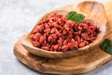 Goji in bowl on stone table. Goji berries in a bowl on table. Top view goji berries with copy space.