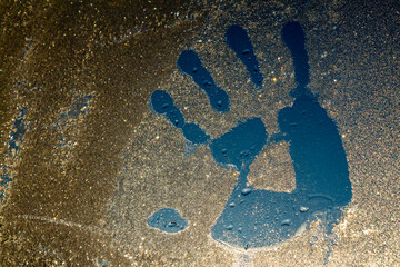 palm print on frozen glass