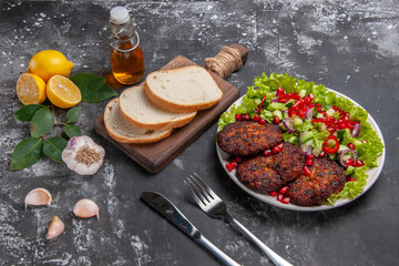 Fototapeta na wymiar half-top view meat cutlets with salad and bread on grey background dish photo food meal