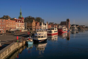 Fototapeta premium Scenic view to the picturesque skyline and colorful harbor of the town of Kappeln.