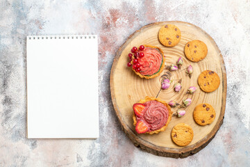 top view delicious creamy cakes with cookies on light desk candy photo biscuit sweet