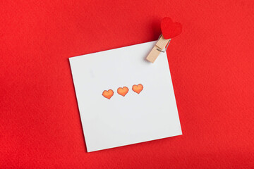 Flatlay red hearts, love card on a red background. Concept of Valentine's Day, wedding. Copy space.