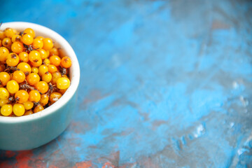 bottom half view sea buckthorn on blue table free space