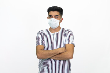 Young male wearing a medical face mask. Isolated image and white background.