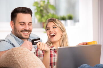 Excited couple shopping online at home