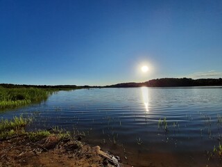 Sunset with reflection in the lake. The photo is distinguished by blue tones.