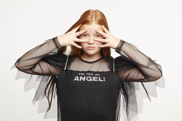 teen girl with long red hair in black angel dress