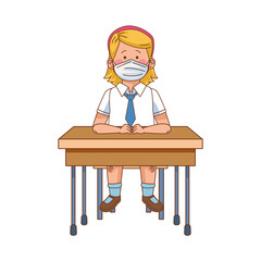 little student girl wearing medical mask seated in school desk