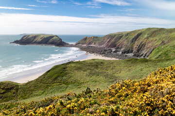 View of Gateholm Island from the Wales Coast Path, Pembrokeshire, UK. Marloes sands, or beach, below the cliff path. Summer's day.