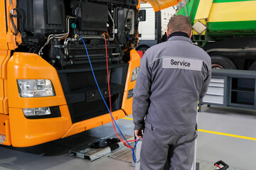 Truck on computer diagnostics in a car service. Servicing and repairing trucks in a large garage....