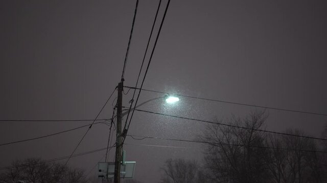 Heavy snow is falling visible from light post