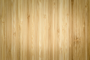 Wood texture with dark corners and light center. There is free space for text. Vertical wood fibers. Focusing in the center of the frame.