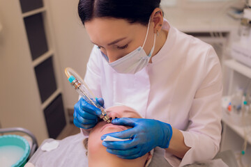 Woman cleaning skin pores using vacuum blackhead remover, cosmetic procedure.
