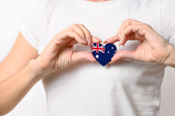 Love Australia. The girl holds a heart in the form of the flag of Australia on her chest. Australian patriotism concept