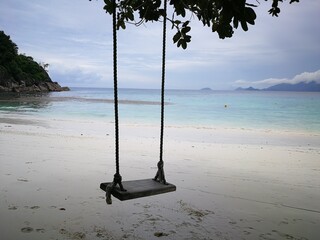 Wooden swings on the exotic island beach in Seychelles