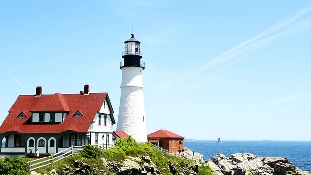 Cliff building Portland Head Lighthouse cinemagraph loop and horizon in Fort Williams park in Cape Elizabeth, Maine during summer day