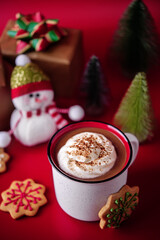 Obraz na płótnie Canvas Winter Christmas holidays background with Cup of cocoa or hot chocolate with whipped cream with cinnamon sprinkles