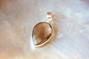 Silver pendant with natural mineral stone on natural background