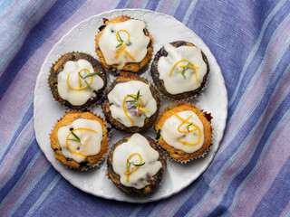 Blueberry cupcakes with orange and rosemary flowers