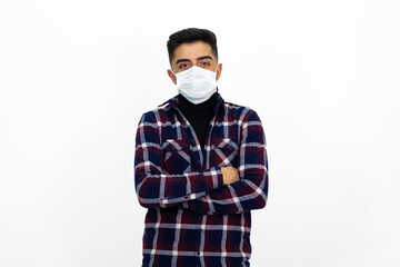Handsome young man male model. He is wearing a medical mask and a dark checkered shirt.