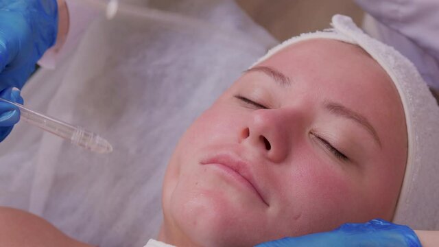 Skin Care. Beautiful Healthy Woman Getting Her Skin Analized By Cosmetologist, Using Skin Analyzer Professional Beauty Equipment For Face Skin Analysis At Cosmetology Center.