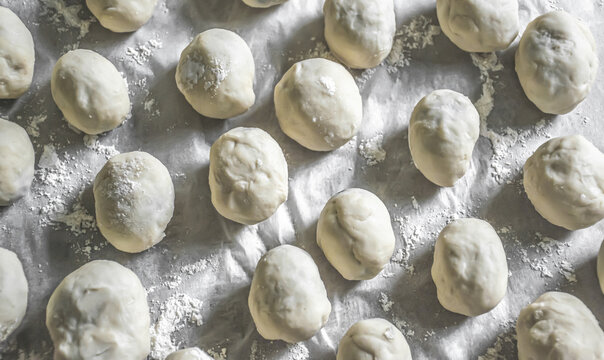Symmetrical image of round dumplings. Top view image. Food art concept. Making of fruit dumplings.	