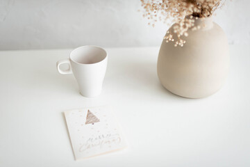 cup of coffee , vase and christmas card