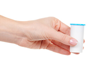 Hand with homeopathy bottle isolated on white background.