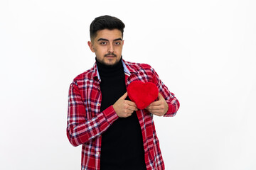 Young man wearing a red striped shirt, holding a heart-shaped gift box in his hand.