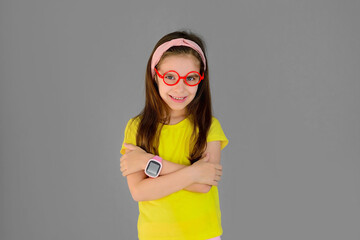 Cute Girl Kid and pink children's Smart Watch isolated on gray background. Protection and control.