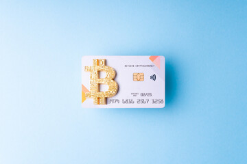 Bitcoin paying symbol. Bank bitcoin cryptocurrency card as shopping and trading concept.