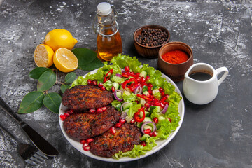 Obraz na płótnie Canvas front view meat cutlets with tasty salad and bread on grey background meal dish photo food