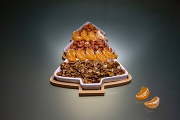sectional plate filled with peanuts, almond, walnuts and Mandarin orange