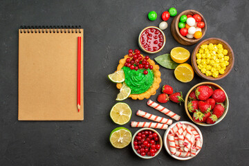 top view yummy cake with candies and fruits on dark background cookies biscuit sweet