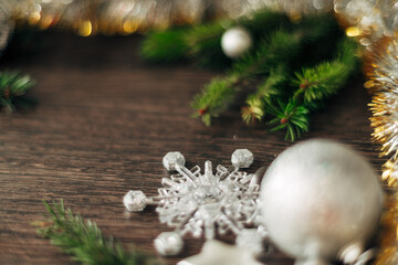 Christmas Tree Branches and Snowflakes on a Brown Background with Copy Space
